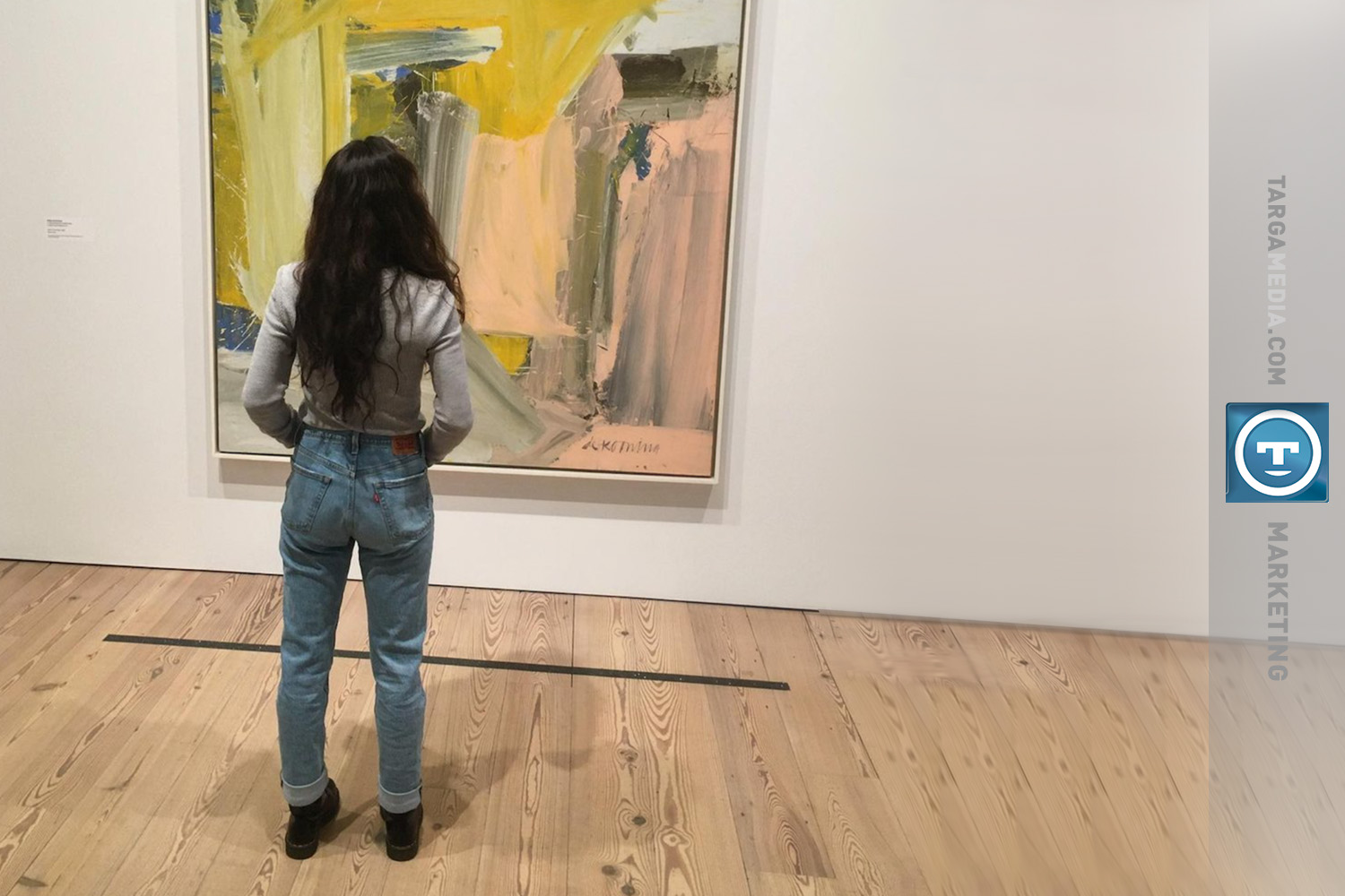 Woman looking at a painting in a gallery