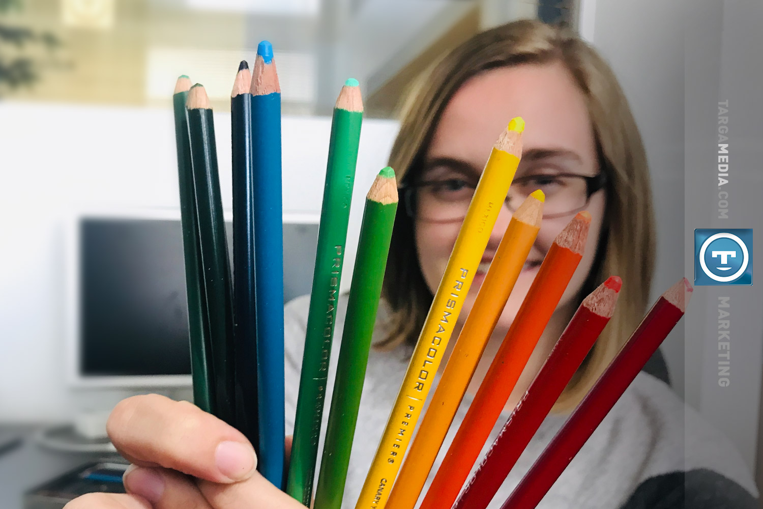 Maddie Gray holding prismacolors from her example of the smallest viable market